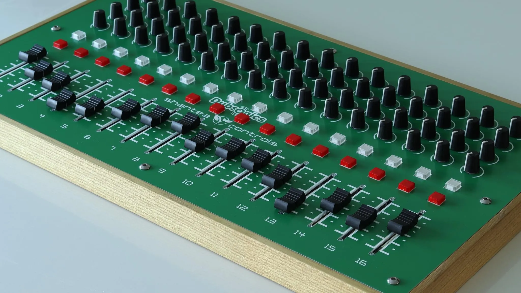 Close-up of DubFocus 16 faders, knobs and illuminated buttons